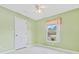 Bright bedroom featuring a ceiling fan and a window with a view of the outdoors at 10151 Sw 41St Ter, Ocala, FL 34476