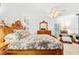 Bright bedroom with light-colored walls, wooden furniture, and patterned bedding at 10151 Sw 41St Ter, Ocala, FL 34476