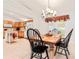 Dining area with a wooden table, black chairs, and chandelier at 10151 Sw 41St Ter, Ocala, FL 34476