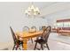 Inviting dining room with hardwood table, black chairs, and decorative chandelier at 10151 Sw 41St Ter, Ocala, FL 34476