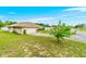 Exterior view showing the side of the home, a driveway, and a well-manicured lawn at 10151 Sw 41St Ter, Ocala, FL 34476