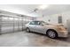 Attached garage featuring a car, garage door, and an automatic door opener at 10151 Sw 41St Ter, Ocala, FL 34476