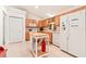 Functional kitchen featuring wooden cabinets, white appliances, and center island at 10151 Sw 41St Ter, Ocala, FL 34476