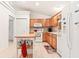 Functional kitchen featuring wooden cabinets, white appliances, and center island at 10151 Sw 41St Ter, Ocala, FL 34476