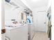 Laundry room with washer, dryer, wire shelving, and hanging space at 10151 Sw 41St Ter, Ocala, FL 34476