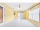 Spacious living room features bright yellow walls and a ceiling fan with a light fixture at 10151 Sw 41St Ter, Ocala, FL 34476