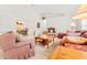 Cozy living room with patterned sofas, wooden coffee table, and view to dining area at 10151 Sw 41St Ter, Ocala, FL 34476