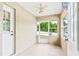 Enclosed porch with white trim, screen windows, and door offering views of the landscaped yard at 10151 Sw 41St Ter, Ocala, FL 34476