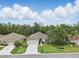 An aerial view showcases a beautiful home with lush landscaping and a sprawling green lawn at 11728 Se 91St Cir, Summerfield, FL 34491
