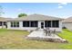 A cozy backyard featuring a quaint patio set on a well-maintained lawn, perfect for outdoor relaxation at 11728 Se 91St Cir, Summerfield, FL 34491