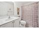 Bright bathroom featuring single sink vanity with white counter top and shower with curtain at 11728 Se 91St Cir, Summerfield, FL 34491