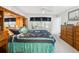 Bright bedroom features large window and an eye-catching colorful quilt on the bed at 11728 Se 91St Cir, Summerfield, FL 34491