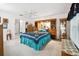 Comfortable bedroom with ceiling fan, carpet flooring, and decorative shelving at 11728 Se 91St Cir, Summerfield, FL 34491