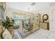 Charming dining room with chandelier, decorative window coverings, and display cabinet at 11728 Se 91St Cir, Summerfield, FL 34491