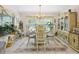 Elegant dining area with chandelier lighting and decoratively furnished accents at 11728 Se 91St Cir, Summerfield, FL 34491