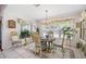 Bright dining room featuring a chandelier, large windows, and a decorative hutch at 11728 Se 91St Cir, Summerfield, FL 34491