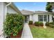 Charming home with meticulously maintained landscaping and a walkway leading to the front door at 11728 Se 91St Cir, Summerfield, FL 34491