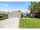 Charming single-story home with a well-manicured lawn and a two-car garage at 11728 Se 91St Cir, Summerfield, FL 34491