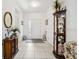 Inviting foyer with tile flooring, decorative furnishings, and a view of the front door at 11728 Se 91St Cir, Summerfield, FL 34491