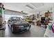 Functional garage featuring ample storage space, open door and a parked car at 11728 Se 91St Cir, Summerfield, FL 34491