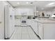 Bright kitchen featuring white cabinetry, tile flooring, and modern appliances at 11728 Se 91St Cir, Summerfield, FL 34491