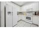 Well-lit kitchen with modern appliances, including a large refrigerator and microwave at 11728 Se 91St Cir, Summerfield, FL 34491