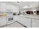 Spacious kitchen area featuring white cabinets, modern appliances, and ample counter space at 11728 Se 91St Cir, Summerfield, FL 34491