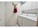 Laundry room with cabinetry above washer and dryer at 11728 Se 91St Cir, Summerfield, FL 34491