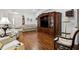 Open-concept living area with hardwood floors, comfortable seating, and a decorative media center at 11728 Se 91St Cir, Summerfield, FL 34491