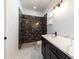 Modern bathroom with a single vanity, dark wood cabinets, and a luxurious walk-in shower at 13741 Sw 81St Cir, Ocala, FL 34473