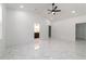 Spacious bedroom with sleek ceiling fan and marble floors, offering a bright and airy feel at 13741 Sw 81St Cir, Ocala, FL 34473