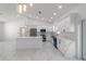 Modern kitchen with white cabinetry, quartz countertops, stainless steel appliances, and a large island at 13741 Sw 81St Cir, Ocala, FL 34473