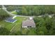 Aerial shot showcasing a backyard with screened in porch, bordered by a fence, with green trees at 144 Malauka Pass, Ocklawaha, FL 32179