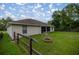 Spacious backyard featuring a fire pit, a wood fence, and a screened patio on the home at 144 Malauka Pass, Ocklawaha, FL 32179