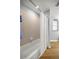 Bathroom features include tiled walls, a bathtub with shower, and wood-look flooring at 144 Malauka Pass, Ocklawaha, FL 32179