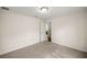 This bedroom is spacious with neutral carpet, light walls and an open door at 144 Malauka Pass, Ocklawaha, FL 32179