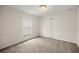 Bedroom featuring neutral carpet, light walls, and a large window at 144 Malauka Pass, Ocklawaha, FL 32179
