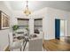 Charming dining area with a glass table and backyard access at 144 Malauka Pass, Ocklawaha, FL 32179