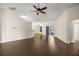 Spacious living room featuring dark hardwood floors and a ceiling fan at 144 Malauka Pass, Ocklawaha, FL 32179