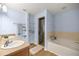 Relaxing bathroom featuring a tub and a separate glass shower at 144 Malauka Pass, Ocklawaha, FL 32179