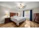 Comfortable main bedroom with hardwood floors, ceiling fan, and natural light at 144 Malauka Pass, Ocklawaha, FL 32179