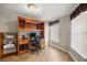 Cozy home office features laminate wood floors, built-in shelving, and a window with privacy blinds at 144 Malauka Pass, Ocklawaha, FL 32179