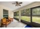 Screened patio with wood benches and a view of the fenced backyard and trees at 144 Malauka Pass, Ocklawaha, FL 32179