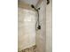 Modern shower with stone floor and stylish black shower head and fixtures at 144 Malauka Pass, Ocklawaha, FL 32179