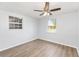A spacious bedroom with two windows and ceiling fan and light wood laminate flooring at 14761 Sw 35Th Terrace Rd, Ocala, FL 34473