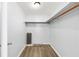 A well-lit walk-in closet with ample shelving and wood-look flooring at 14761 Sw 35Th Terrace Rd, Ocala, FL 34473