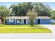 Charming single-story home with blue exterior, well-maintained lawn, and mature landscaping at 14761 Sw 35Th Terrace Rd, Ocala, FL 34473