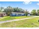 Well-maintained blue single-story home with a large front yard and mature palm trees at 14761 Sw 35Th Terrace Rd, Ocala, FL 34473