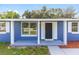 Close-up of a home's front porch featuring a modern black door and freshly painted porch at 14761 Sw 35Th Terrace Rd, Ocala, FL 34473