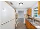 Bright kitchen features a stainless steel sink, wood cabinets, granite countertops, and tile backsplash at 14761 Sw 35Th Terrace Rd, Ocala, FL 34473